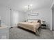 This is a bedroom with grey walls, a unique light fixture, grey carpet and a window on the left at 208 S Conger St, , IN 47272