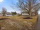 Spacious home property featuring a mix of lawn, trees, and a gravel driveway at 208 S Conger St, , IN 47272