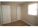 Bright bedroom features wood floor, white door, white trim and a window for natural light at 2261 N Centennial St, Indianapolis, IN 46222