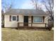 Charming home with yellow siding, dark shutters, and a welcoming front porch at 2261 N Centennial St, Indianapolis, IN 46222