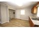 The kitchen features new laminate flooring and wooden cabinets at 2261 N Centennial St, Indianapolis, IN 46222