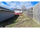 Backyard view showing fence and exterior of home with lawn and garden space at 243 S 3Rd Ave, Beech Grove, IN 46107