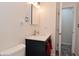 Well-lit bathroom featuring a navy blue vanity with a white countertop and modern fixtures at 243 S 3Rd Ave, Beech Grove, IN 46107