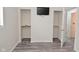 Bright bedroom featuring wood floors, two closets, and a wall-mounted TV at 243 S 3Rd Ave, Beech Grove, IN 46107