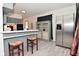 Functional kitchen with bar seating, stainless steel appliances, and ample counter space at 243 S 3Rd Ave, Beech Grove, IN 46107