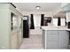 This kitchen features gray cabinets, modern appliances, and wood-look vinyl flooring at 243 S 3Rd Ave, Beech Grove, IN 46107