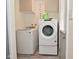 Laundry area with modern appliances, a 'LAUNDRY' sign, and a gray door with a window at 243 S 3Rd Ave, Beech Grove, IN 46107