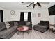 Comfortable living room showcasing a large sectional sofa, modern ceiling fan and plank floors at 243 S 3Rd Ave, Beech Grove, IN 46107
