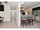 Living room with a view into the kitchen, featuring a breakfast bar and an adjacent hall at 243 S 3Rd Ave, Beech Grove, IN 46107