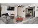 Spacious living room with a large TV, open access to the kitchen, and modern ceiling fan at 243 S 3Rd Ave, Beech Grove, IN 46107