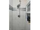Shower stall featuring modern fixtures and sleek grey and white tile at 243 S 3Rd Ave, Beech Grove, IN 46107
