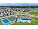 Community aerial view showcases homes, community pool, tennis courts, and meticulously landscaped grounds at 2556 Lamar Dr, Whitestown, IN 46075