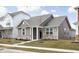 Charming single-Gathering home featuring stone accents, neutral siding, and a well-manicured lawn at 2556 Lamar Dr, Whitestown, IN 46075