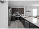 Modern kitchen featuring stainless steel appliances, dark wood cabinets, and a large island with a white countertop at 2556 Lamar Dr, Whitestown, IN 46075