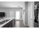 Bright kitchen with white quartz countertops, stainless steel appliances, and wood-look floors at 2556 Lamar Dr, Whitestown, IN 46075