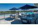 Poolside patio displays tables, chairs, umbrellas, and serene views of the pool and surrounding landscape at 2556 Lamar Dr, Whitestown, IN 46075
