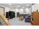 Basement living room with a comfy couch, TV, and shelving, perfect for relaxation and entertainment at 2665 Chestnut St, Columbus, IN 47201