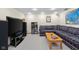 Comfortable basement living room featuring a cozy couch, TV, and shelving, ideal for relaxing and entertaining at 2665 Chestnut St, Columbus, IN 47201