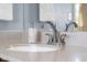 Bathroom sink with light countertops, a modern faucet, and white towels hanging nearby at 2665 Chestnut St, Columbus, IN 47201