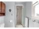 Bathroom featuring a glass enclosed shower, a window, and light blue walls at 2665 Chestnut St, Columbus, IN 47201
