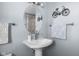 Bathroom sink featuring modern fixtures, a decorative mirror, and a towel rack adds a stylish touch to the space at 2665 Chestnut St, Columbus, IN 47201