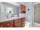 Bathroom featuring a vanity with wood cabinets, a shower stall, and light blue walls at 2665 Chestnut St, Columbus, IN 47201