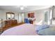 Bright bedroom featuring hardwood floors, a ceiling fan, and a view into the ensuite bath at 2665 Chestnut St, Columbus, IN 47201