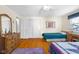 Bedroom featuring hardwood floors, a bed, dresser, and a purple area rug at 2665 Chestnut St, Columbus, IN 47201