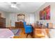 Bedroom featuring hardwood floors, a ceiling fan, with a beautiful wooden desk and colorful art at 2665 Chestnut St, Columbus, IN 47201