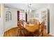 Elegant dining room featuring wood floors, a large table, and decorative lighting at 2665 Chestnut St, Columbus, IN 47201