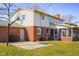 Home exterior with brick and siding, basketball hoop, grill, and enclosed patio at 2665 Chestnut St, Columbus, IN 47201