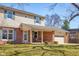 Charming two-story home with a brick facade, covered porch, and attached garage at 2665 Chestnut St, Columbus, IN 47201