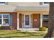 Inviting front porch with a hanging swing, white columns, and a brick facade at 2665 Chestnut St, Columbus, IN 47201
