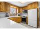 Charming kitchen featuring wooden cabinetry, stainless steel appliances, and a bright window view at 2665 Chestnut St, Columbus, IN 47201
