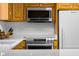 Modern kitchen showcasing stainless steel microwave, oven, and refrigerator with quartz countertops at 2665 Chestnut St, Columbus, IN 47201