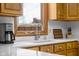 Close-up of a kitchen sink with stainless steel fixtures, a window, and neutral countertop at 2665 Chestnut St, Columbus, IN 47201