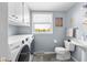 Laundry area with a washer, dryer, sink, and storage, providing a convenient and efficient space for chores at 2665 Chestnut St, Columbus, IN 47201