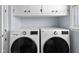 Modern laundry room features LG washer and dryer set with white cabinets above for ample storage at 2665 Chestnut St, Columbus, IN 47201
