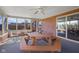 Enclosed sunroom offers brick accents, ceiling fan, and a large picnic table ideal for gatherings at 2665 Chestnut St, Columbus, IN 47201