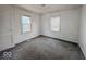 An empty bedroom with gray carpet, neutral walls, and two windows for ample sunlight at 2959 N Lasalle St, Indianapolis, IN 46218
