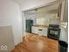Kitchen featuring a refrigerator, stove, sink with faucet and white cabinets at 2959 N Lasalle St, Indianapolis, IN 46218