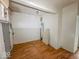Empty room with wood-look floors and a gray door, ready for renovation at 2959 N Lasalle St, Indianapolis, IN 46218