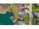 An aerial view of a lakeside property showcasing a well-maintained home, lush green lawn, and serene waterfront setting at 3232 Beech Dr, Columbus, IN 47203
