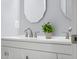 Bathroom vanity with double sinks, modern fixtures, and decorative mirrors create a clean, stylish design at 3232 Beech Dr, Columbus, IN 47203