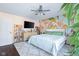 Bright bedroom featuring an accent wall, ceiling fan, and soft, neutral carpet at 3232 Beech Dr, Columbus, IN 47203