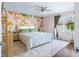 Bright bedroom featuring an accent wall, ceiling fan, and soft, neutral carpet at 3232 Beech Dr, Columbus, IN 47203