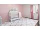 This Bedroom features soft pink walls, a plush rug, and a white crib with a castle wall decal for a charming, cozy atmosphere at 3232 Beech Dr, Columbus, IN 47203