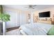 Bright bedroom featuring a ceiling fan, large closets, and soft, neutral carpet at 3232 Beech Dr, Columbus, IN 47203
