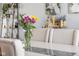 Dining room with bright bouquet centerpiece, neutral decor, and model of Hogwarts in the background at 3232 Beech Dr, Columbus, IN 47203