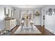 Bright dining room with hardwood floors, elegant chandelier, and large window at 3232 Beech Dr, Columbus, IN 47203